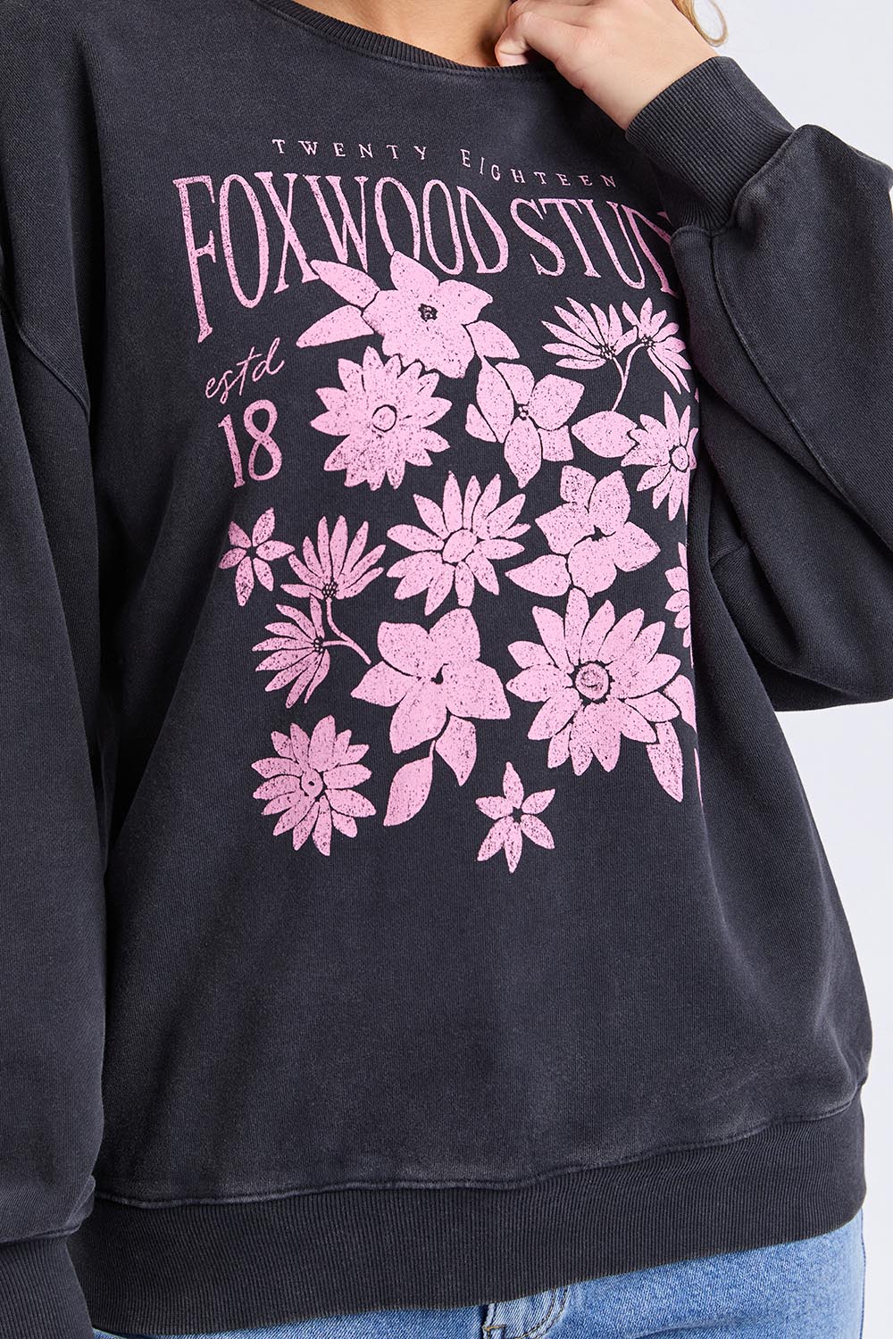 A model wearing the Floret Crew in colour Black (Black), from the front, cropped image