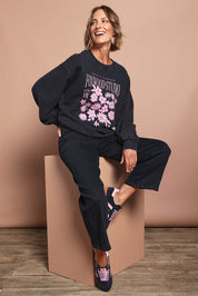 Model Riina wearing size 10 of the Floret Crew in colour Black (Black), from the front, showing the whole outfit