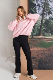 A model wearing the Elements Luxe Rib Pant in colour Black (Black), from the front, showing the whole outfit