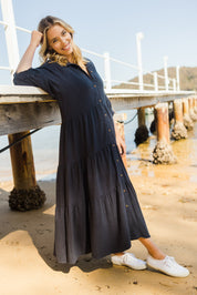 Model Phoebe wearing size 10 of the Sunny Days Dress in colour Navy (Blue), from the front, showing the whole outfit