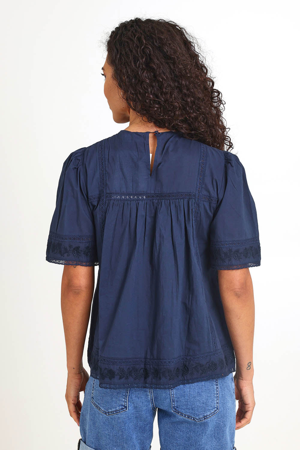 Model Pamelar wearing size 10 of the Juna Top – Dsapphire in colour Dsapphire, from the back