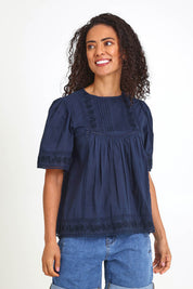 Model Pamelar wearing size 10 of the Juna Top – Dsapphire in colour Dsapphire, in a cropped view