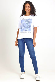 Model Pamelar wearing size 10 of the Studio Rose Tee – White in colour White, from the front