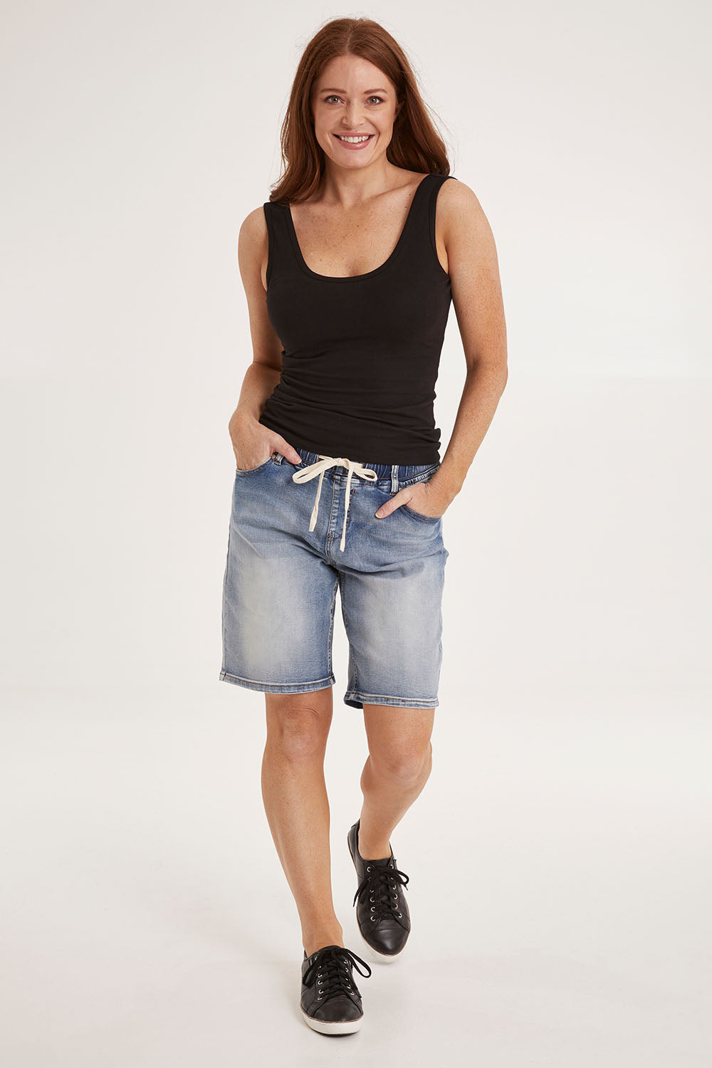 Model Sally wearing size 10 of the Gabby Bermuda in colour Midblue (Blue), from the front, showing the whole outfit