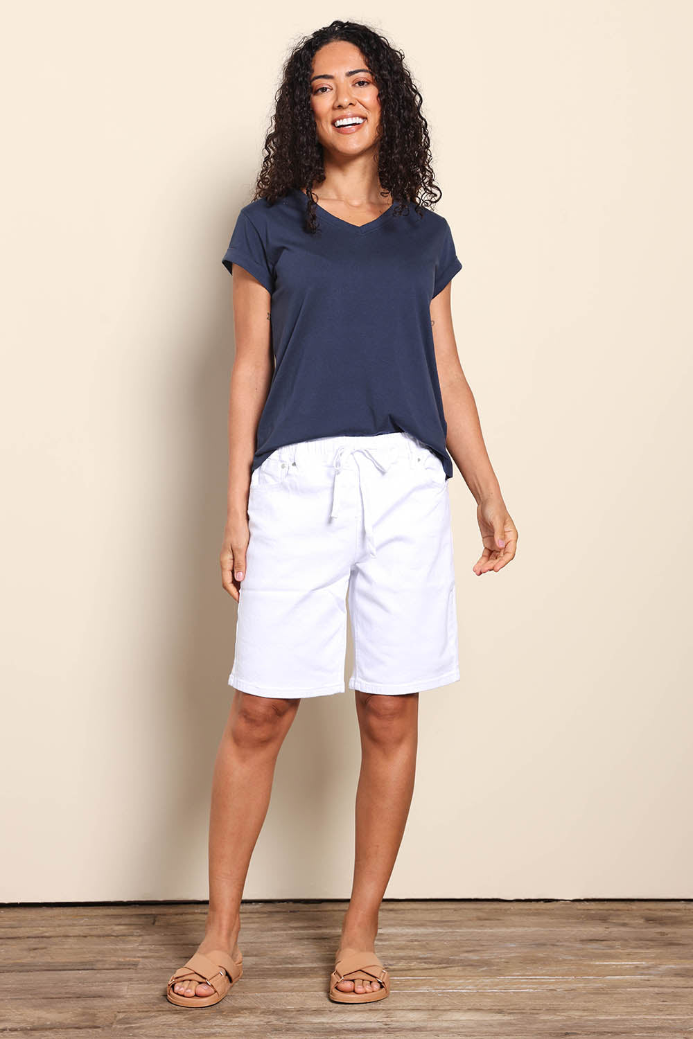 Model Pamelar wearing size 10 of the Gabby Bermuda - White in colour White, from the front
