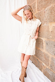 Model Bronte wearing size 10 of the Heidi Dress in colour Ecru, from the front, showing the whole outfit
