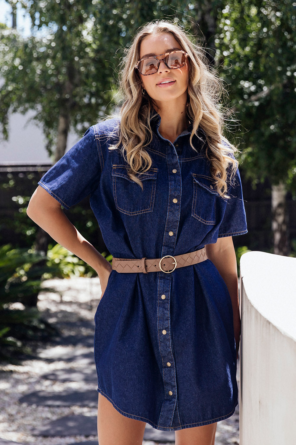 A model wearing the Sorcha Denim Dress in colour Indigoden (Blue), from the front, showing the whole outfit
