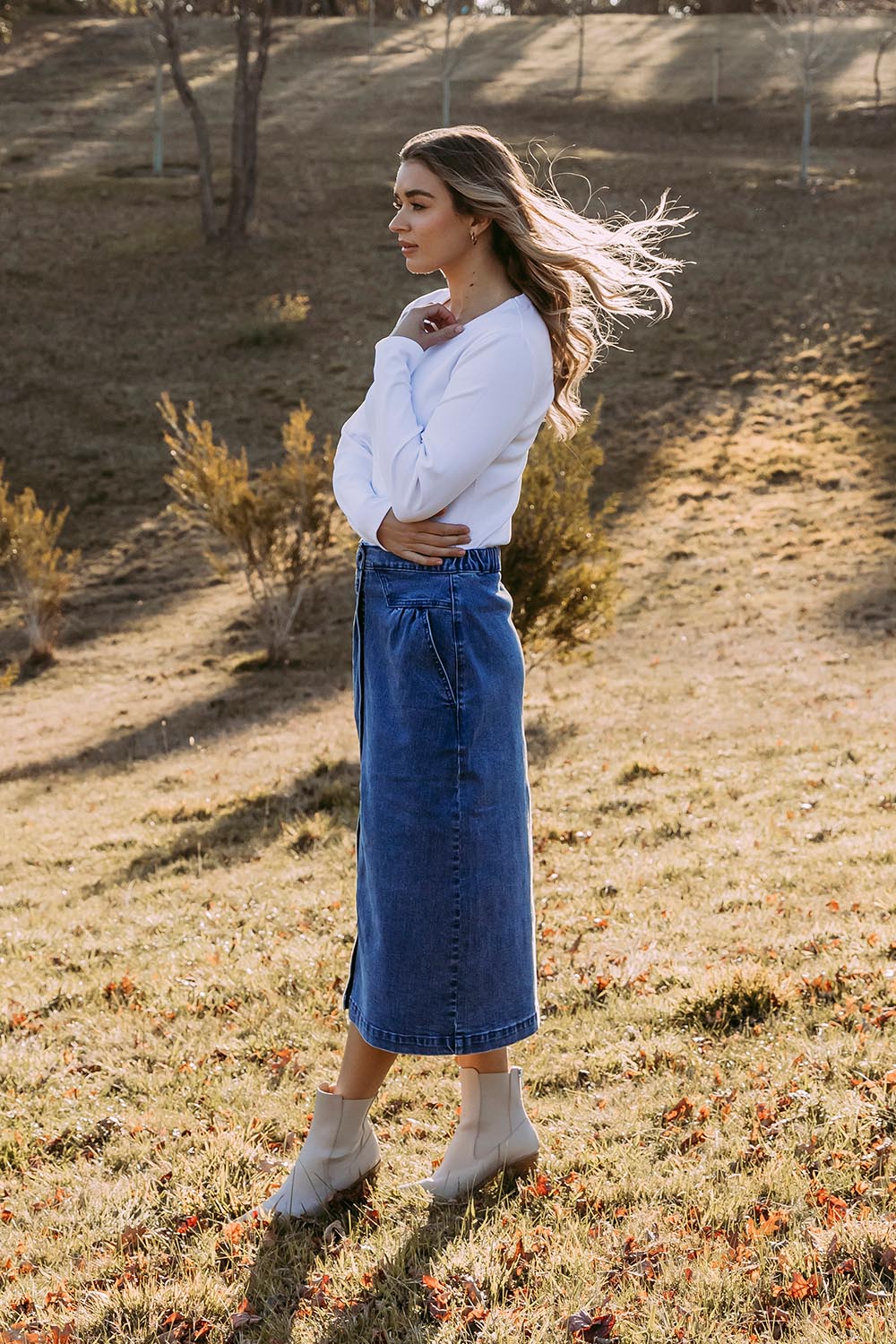A model wearing the Amanda Cotton Blend Midi Skirt in colour Midblue (Blue), from the front, showing the whole outfit