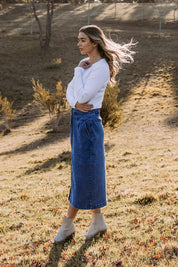 A model wearing the Amanda Cotton Blend Midi Skirt in colour Midblue (Blue), from the front, showing the whole outfit