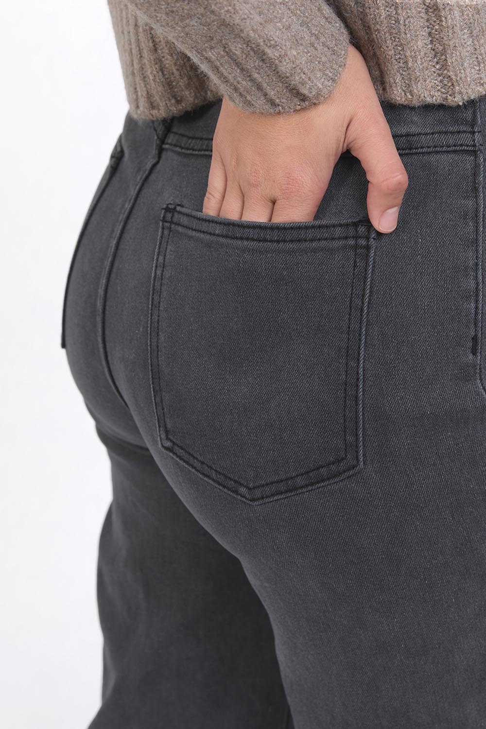 A model wearing the Sarah Wide Leg Jean in colour Washblack (Black), from the front, cropped image