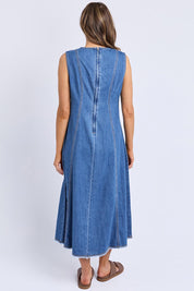 A model wearing the Solene Denim Dress in colour Midblue (Blue), from the back