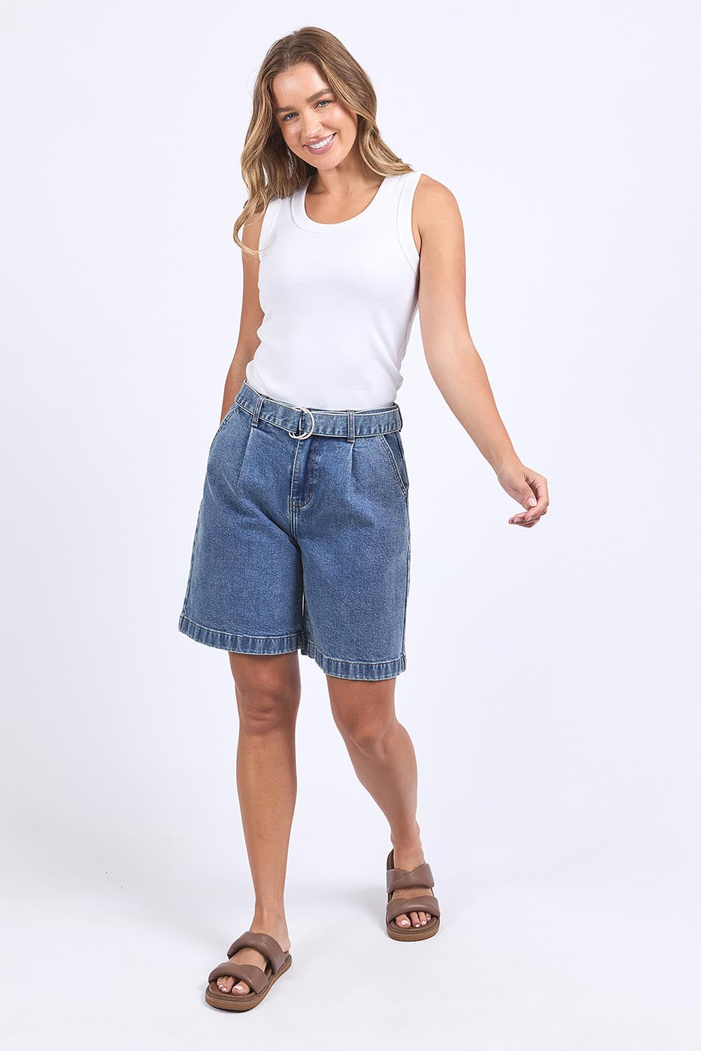 A model wearing the Saint Short in colour Midblue (Blue), from the front, showing the whole outfit