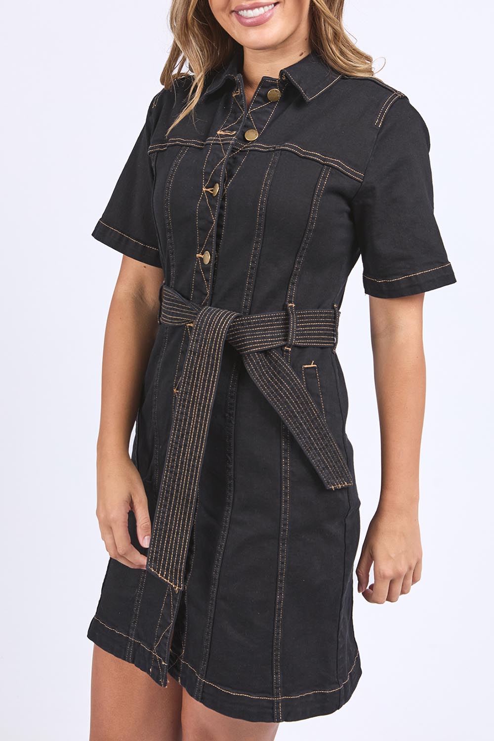 A model wearing the Riva Denim Dress in colour Black (Black), from the front, cropped image