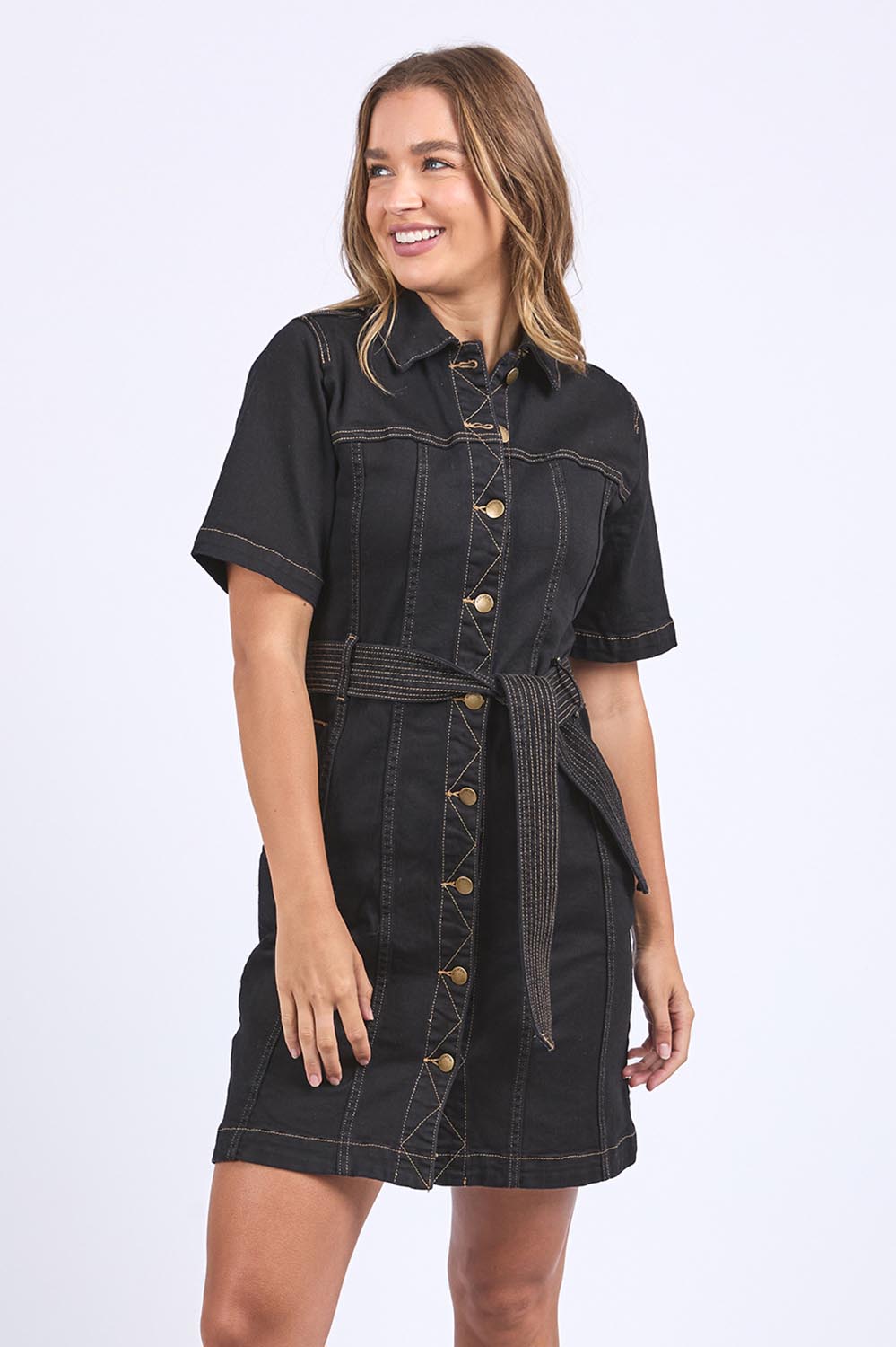 A model wearing the Riva Denim Dress in colour Black (Black), from the front, cropped image