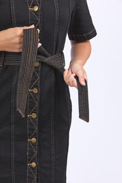 A model wearing the Riva Denim Dress in colour Black (Black), from the front, cropped image