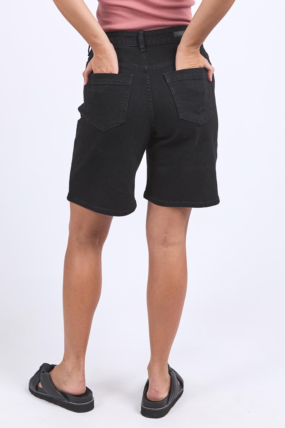 A model wearing the Elements Harley Denim Short in colour Black (Blue), from the back