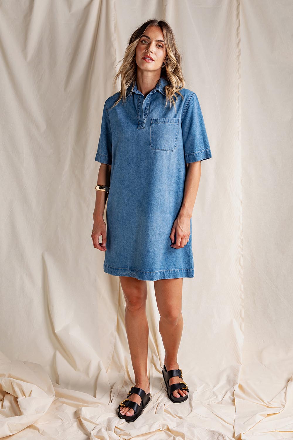 A model wearing the Monte Shirt Dress in colour Midblue (Blue), from the front, showing the whole outfit
