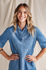 A model wearing the Monte Shirt Dress in colour Midblue (Blue), from the front, showing the whole outfit