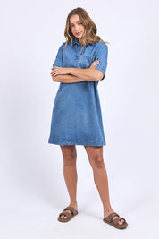 A model wearing the Monte Shirt Dress in colour Midblue (Blue), from the front, showing the whole outfit