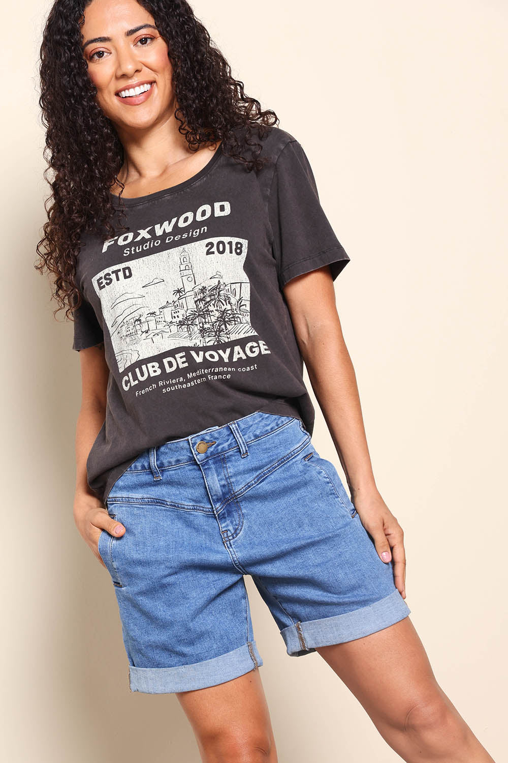 Model Pamelar wearing size 10 of the Elements Devi Denim Shorts - Midblue in colour Midblue, from an angle