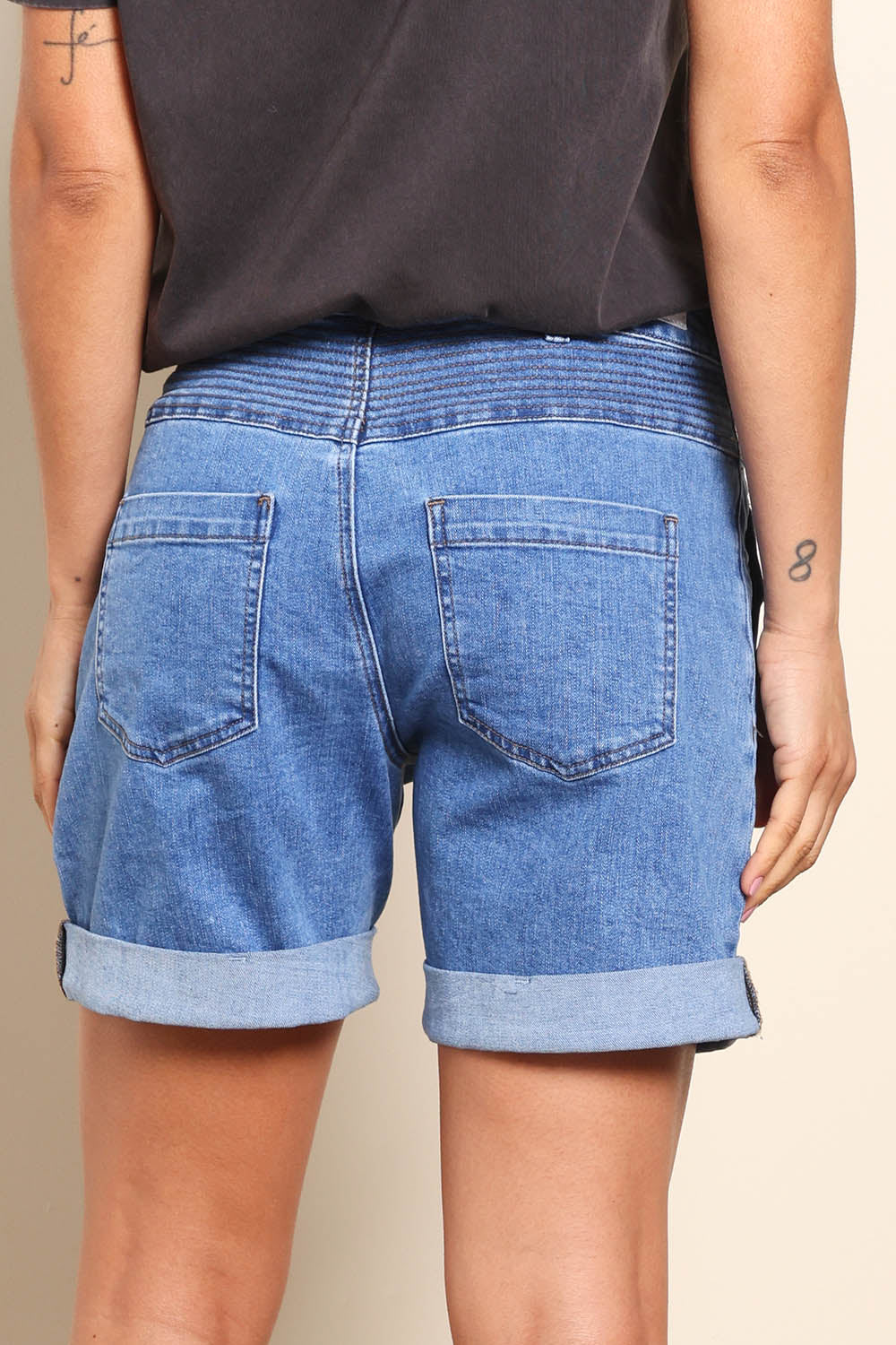 Model Pamelar wearing size 10 of the Elements Devi Denim Shorts - Midblue in colour Midblue, from the back