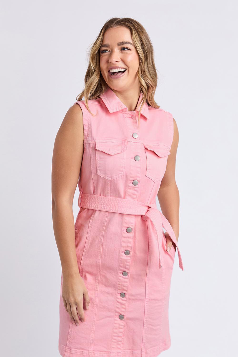 A model wearing the Sleeveless Talbert Denim Dress in colour Palepink (Pink), from the front, cropped image