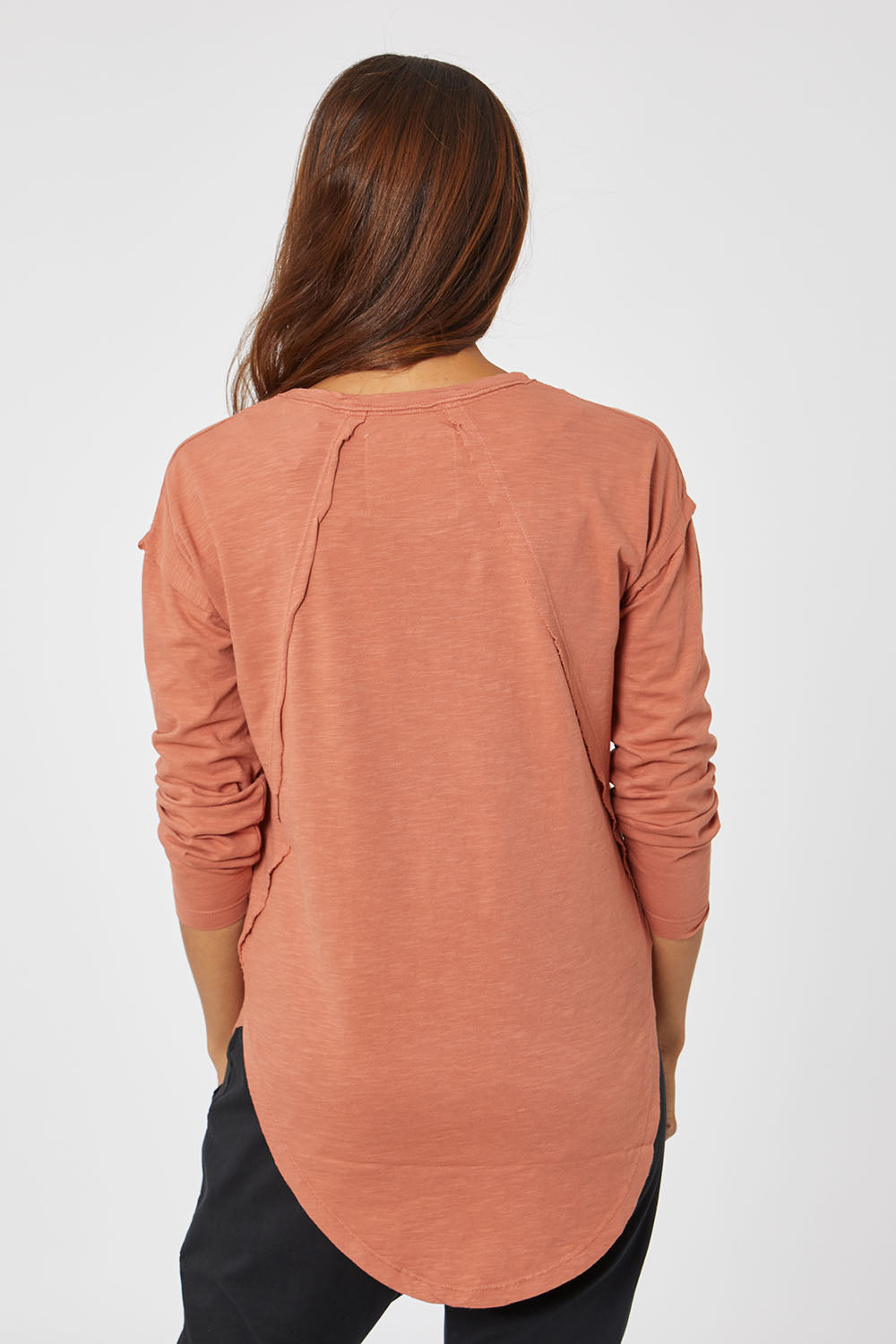 Model Cara wearing size 10 of the Elements Mackenzie Long Sleeve Crew Tee in colour Copper, from the back