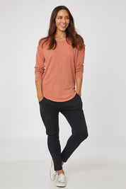 Model Cara wearing size 10 of the Elements Mackenzie Long Sleeve Crew Tee in colour Copper, from the front, showing the whole outfit