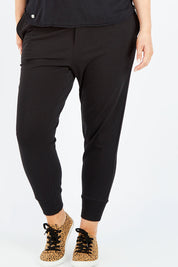 Model Jess wearing size 14 of the Chelsea Pant in colour Black (Black), from the front, cropped image