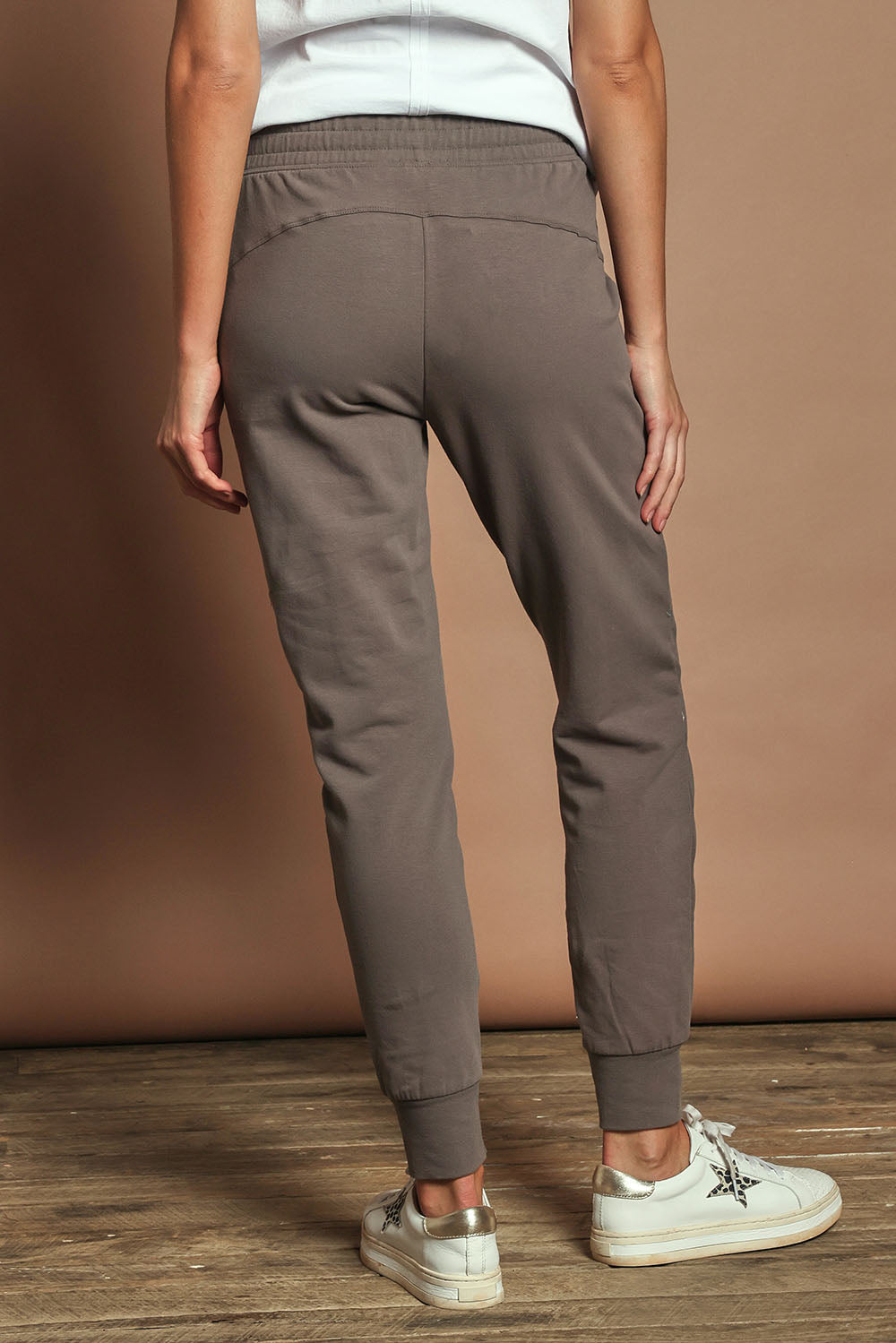 Model Madeline wearing size 10 of the Elements Lazy Days Pant in colour Stonegrey (Grey), from the back