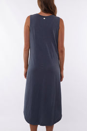 A model wearing the Elements Margot Dress in colour Navy (Blue), from the back
