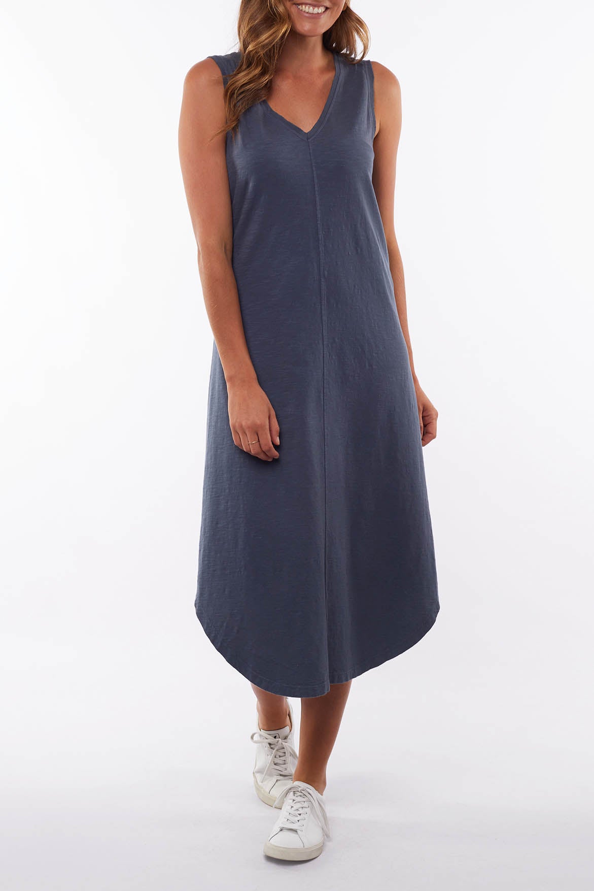 A model wearing the Elements Margot Dress in colour Navy (Blue), from the front, cropped image