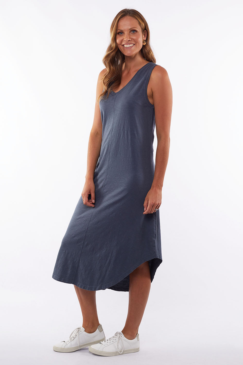 A model wearing the Elements Margot Dress in colour Navy (Blue), from the front, showing the whole outfit