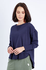 Model Andrea wearing size 10 of the Elements Delilah Crew in colour Navy (Blue), from the front, cropped image