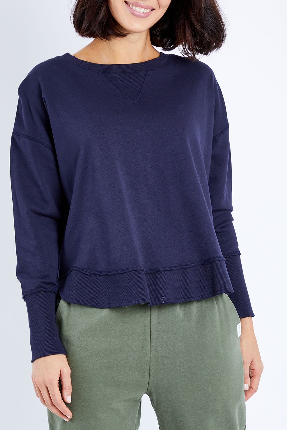 Model Andrea wearing size 10 of the Elements Delilah Crew in colour Navy (Blue), from the front, cropped image