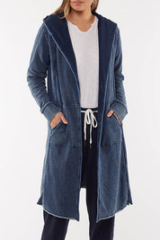 A model wearing the Elements Annie Hooded Cardigan in colour Washedenim (Blue), from the front, cropped image