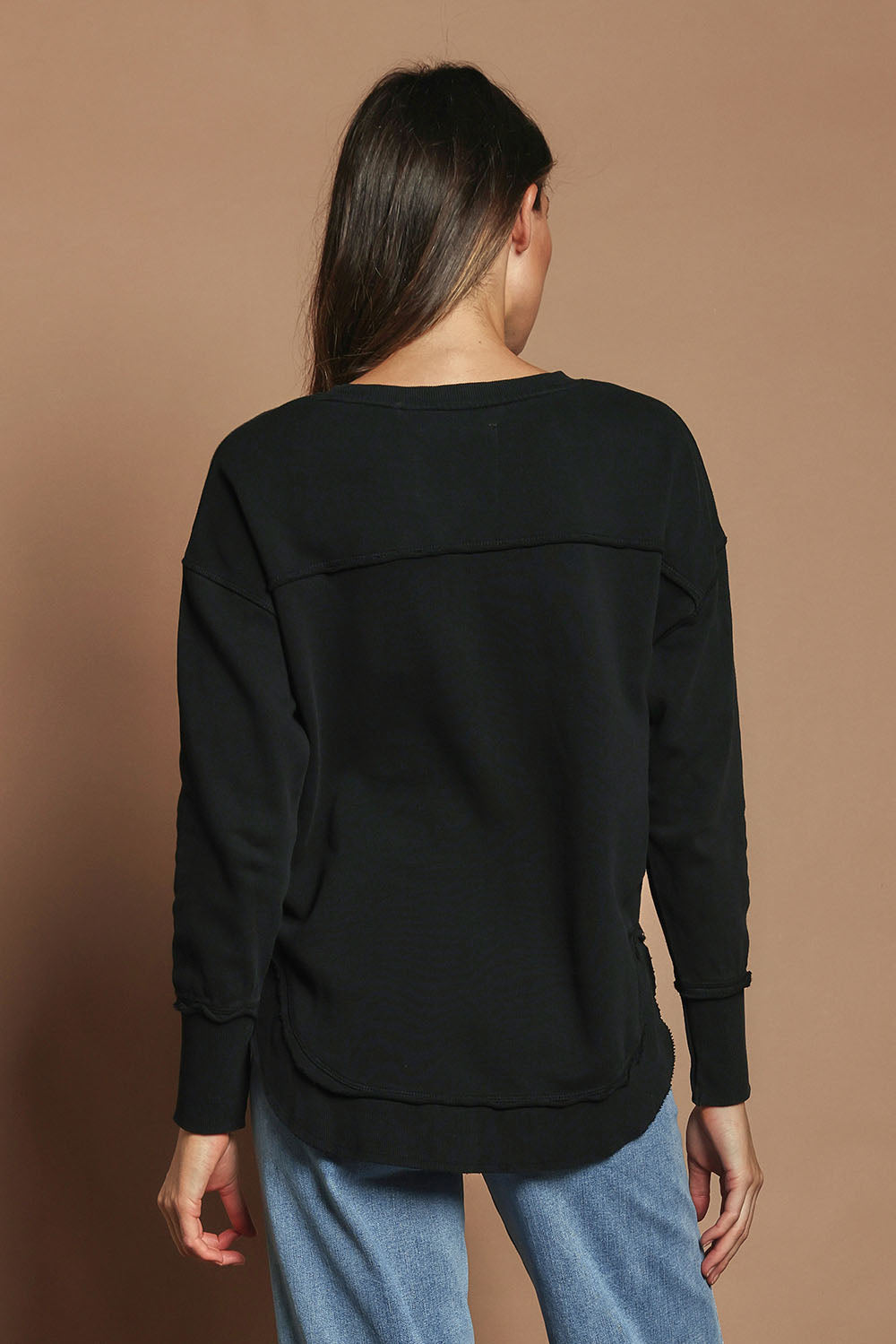 Model Madeline wearing size 10 of the Elements Simplified Cotton Crew in colour Black (Black), from the back