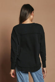 Model Madeline wearing size 10 of the Elements Simplified Cotton Crew in colour Black (Black), from the back