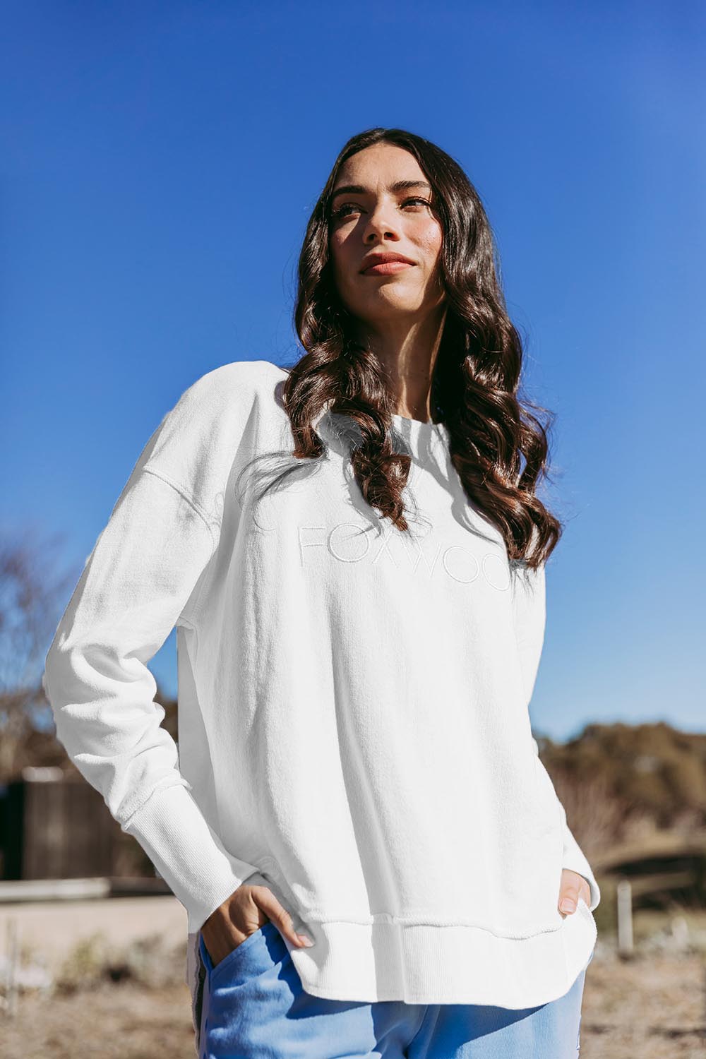A model wearing the Elements Simplified Cotton Crew in colour Ecru (White), from the front, showing the whole outfit