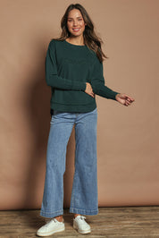 Model Madeline wearing size 10 of the Elements Simplified Cotton Crew in colour Forest (Green), from the front, showing the whole outfit