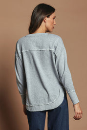 Model Madeline wearing size 10 of the Elements Simplified Cotton Crew in colour Greymarle (Grey), from the back