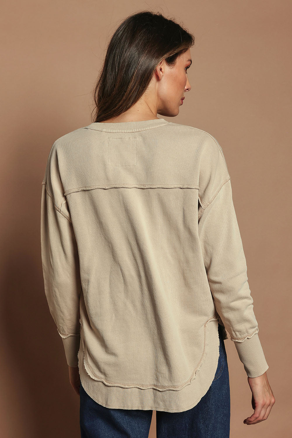Model Madeline wearing size 10 of the Elements Simplified Cotton Crew in colour Oat, from the back