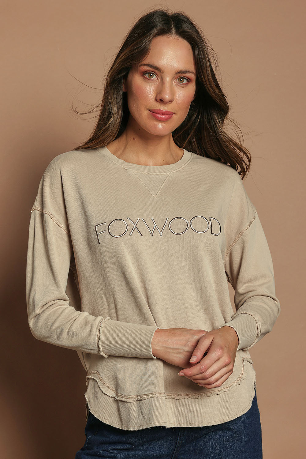 Model Madeline wearing size 10 of the Elements Simplified Cotton Crew in colour Oat, from the front, cropped image