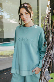 A model wearing the Elements Simplified Cotton Crew in colour Sky (Blue), from the front, showing the whole outfit