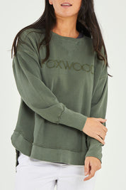 Model Katie wearing size 10 of the Elements Washed Simplified Crew in colour Khaki (Green), from the front, cropped image
