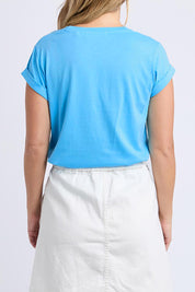 A model wearing the Elements Manly Cotton Tee in colour Azure (Blue), from the back