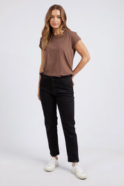 A model wearing the Elements Manly Cotton Tee in colour Chocolate, from the front, showing the whole outfit