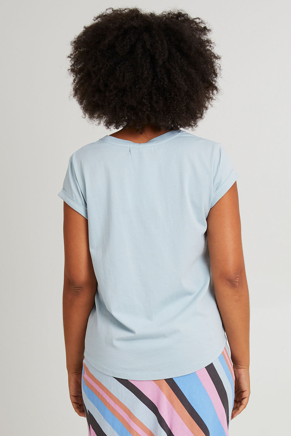 Model Olivia wearing size 10 of the Elements Manly Cotton Tee in colour Dreamblue (Blue), from the back
