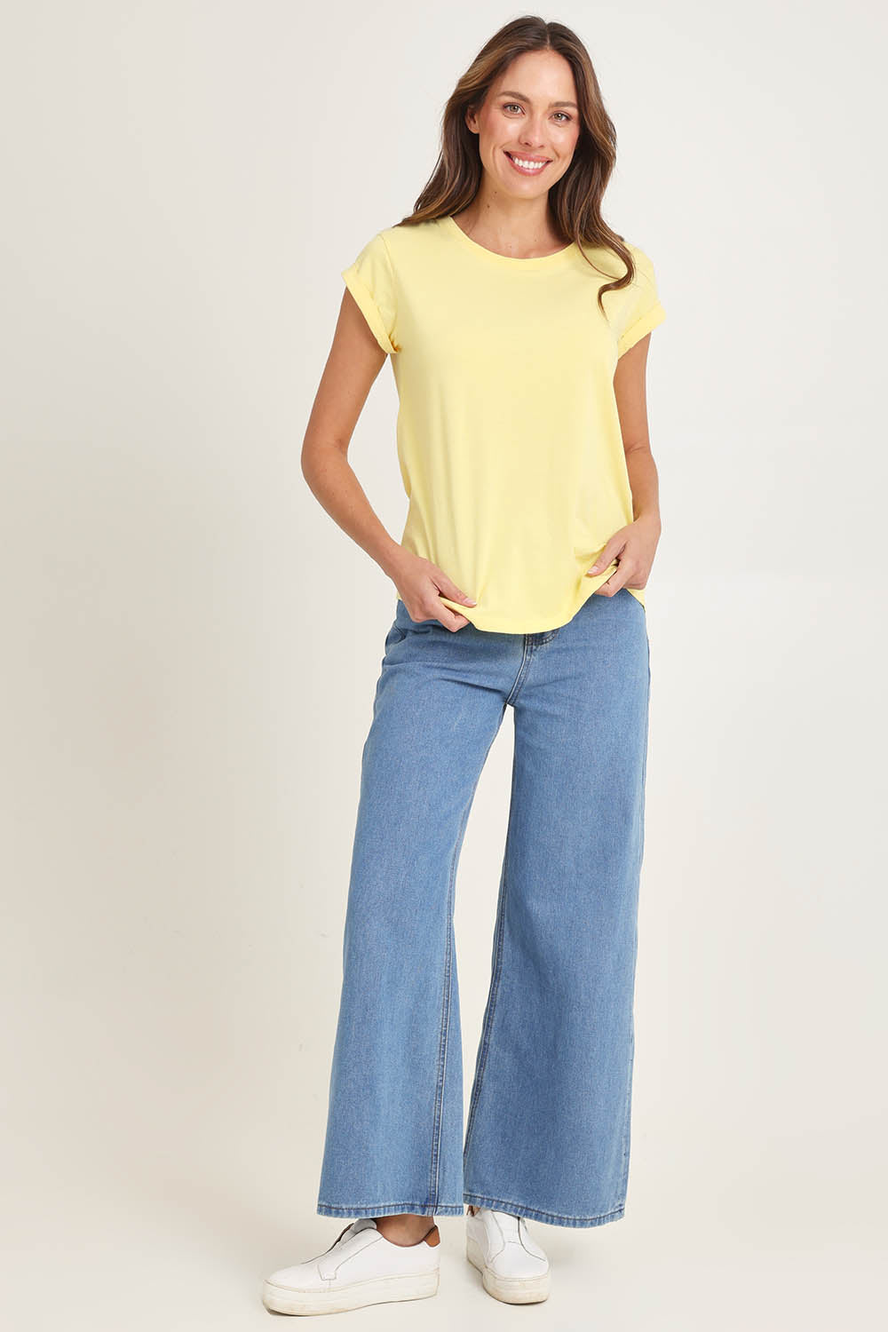 Model Madeline wearing size 10 of the Elements Manly Cotton Tee in colour Sunshine, from the front, showing the whole outfit