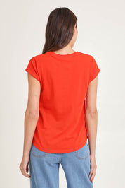 Model Madeline wearing the Elements Manly Cotton Tee in colour Tangelo (Red), from the back